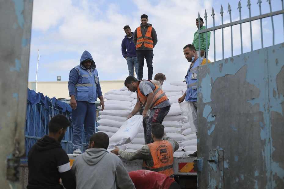 UN workers distribute flour to Palestinians in Rafah during the war - donations provide vital aid.