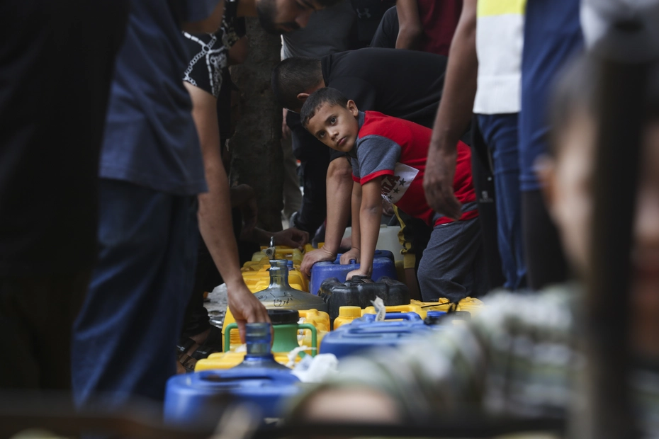 Palestinians collect drinking water in Rafah during bombardments - donations provide vital access to water in times of crisis.