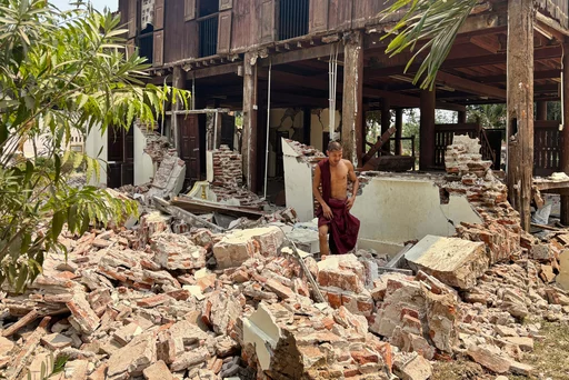 A man walks through the rubble of the Southeast Asian earthquake - emergency help needed desperately.