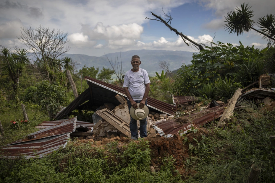 A man stands in front of the ruins of his home in La Reina, Honduras - donations help rebuild after the hurricanes Eta and Iota.