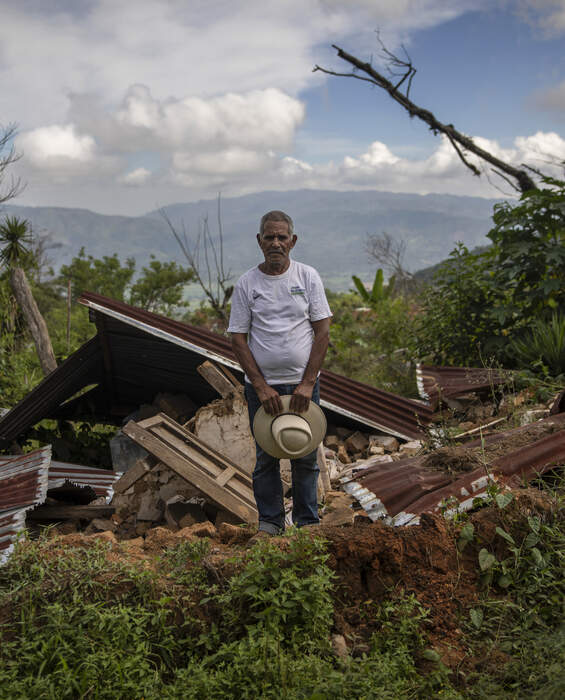 A man stands in front of the ruins of his home in La Reina, Honduras - donations help rebuild after the hurricanes Eta and Iota.